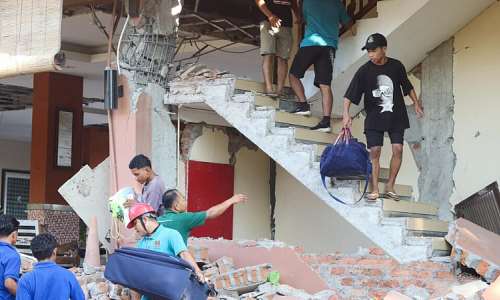 People evacuate from a collapsed building at the Jayakarta hotel in Labuan Bajo, Indonesia, following a powerful earthquake. -  Stringer, Reuters