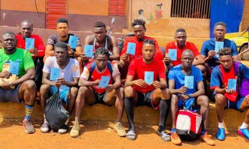 Players from Sierra Leone's Anti-Drugs Strikers FC with their Covid-19 vaccination cards