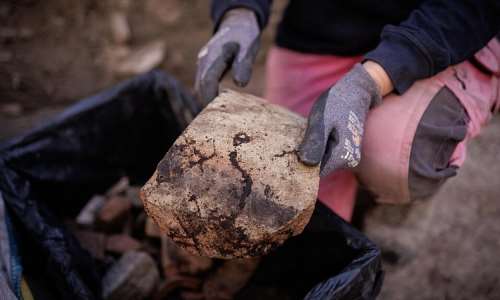 Elodie Perugini, an archeologist with the city of Paris, holds a Gallic wine amphora piece during excavations at an archaeological site on the Ile de la Cit in Paris on September 23, 2026. -  Simon Wohlfahrt, AFP