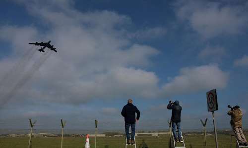 Plane spotters watch as a Boeing B-52 Stratofortress takes off at RAF Fairford airbase, which hosts United States Air Force (USAF) personnel, amid a ceasefire between the United States and Iran, in Fairford, Gloucestershire, Britain, April 23, 2026. - REUTERS - Hannah McKay