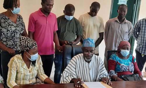 Mr Dassah (flanked by some poultry farmers and egg sellers) reading the press statement