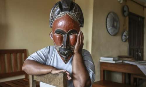 A woman deported from the US to Cameroon in an immigration crackdown shields her face with a mask as she poses for a photograph in Yaounde on September 9, 2026.  By - (AFP)