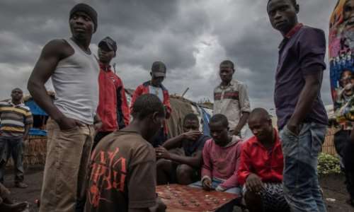 Ex-combatants play a game of checkers to pass the time at the Mubambiro cantonment camp. By Guerchom NDEBO (AFP)
