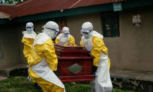 Members of a Congolese Red Cross team carry the coffin of a woman suspected of having died from Ebola in the eastern city of Bunia.  By Jospin Mwisha (AFP)