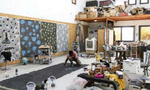 Omar Ba revels in the beauty of black', starting most of his works on a dark black canvas background. By JOHN WESSELS AFP