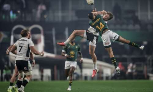 South Africas No. 14 Jaco Williams jumps for the ball against Wales wing Ellis Mee.  By PHILL MAGAKOE (AFP)
