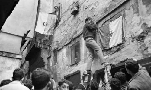 Young Algerians hang their country's national flag on buildings in the capital on July 6, 1962, a day after the North African country won its independence from France following an eight-year war. By - AFPFile