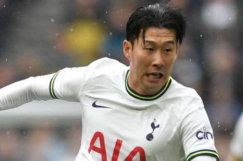 A fan in the stands holds up a Tottenham Hotspur's Son Heung-min