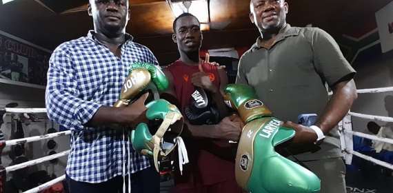 John Laryea receives branded training equipment as he prepares to train and