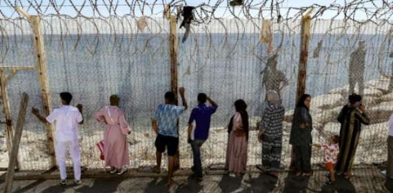 Moroccans gather at Ceuta border, desperate for news of loved