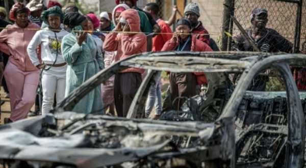 Suspects in the Johannesburg shooting torched two vehicles before fleeing.  By EMMANUEL CROSET (AFP)