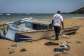 This file photo shows a member of the International Organization for Migration (IOM) inspecting the abandoned wreckage of a boat that capsized while attempting to transport migrants to Yemen along the so-called Eastern Route at Gehere beach, near Obock, Djibouti, on April 12, 2026. -  Luis Tato, AFP