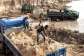 Miners shovel sand into trucks in an area destroyed by sand mining on the outskirts of Gunjur in the Gambia. -  AFP - JOHN WESSELS