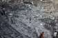 Palestinians inspect destroyed buildings after they were targeted by Israeli strikes the previous night in Deir al Balah, central Gaza Strip on July 29, 2026. -  Eyad Baba, AFP