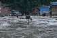 A resident walks down a street flooded with mud in Devighat, in Nepals Nuwakot District, on August 26, 2026. -  Prakash Mathema, AFP