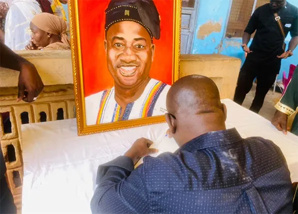 Member of Parliament for Bolga East, Isaac Adongo, signing the book of condolence at the residence of the late Ibrahim Murtala Mohammed in Tamale