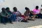 Frustrated parents sitting on bare floor in hope of securing placements for their wards