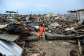 A boy in the Ivorian team jersey at his demolished home in Koumassi Campement.  By Sia KAMBOU (AFP)