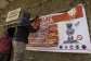 A man hangs an Ebola awareness banner in the Kigonze displaced persons camp in Bunia, in the eastern DRC.  By Glody MURHABAZI (AFP)