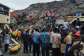 Residents and rescuers use an excavator to search for bodies after a landslide struck a dumpsite in Conakry, Guinea.  By - (AFP)