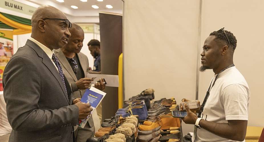 Bright Aferi co-founder of Hillbill interacting with clients at the ghana expo in kenya