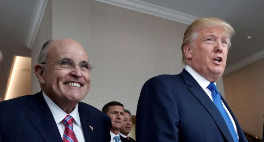 Donald Trump walks with Rudolph Giuliani through the new Trump International Hotel in Washington, DC, on Sept. 16, 2016.Mike Segar / Reuters file