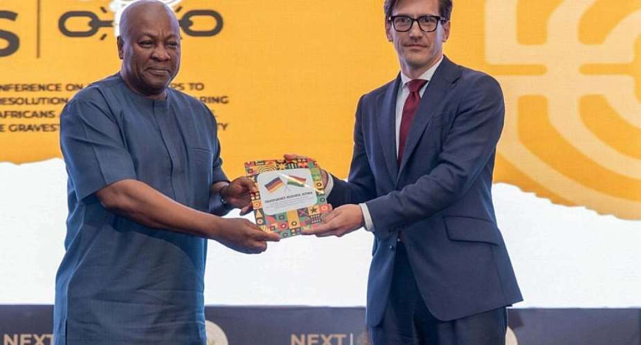 German Ambassador H.E. Frederik Landshft presenting a catalogue of artefacts to President John Dramani Mahama. -  Ghana Ministery of Foreign Affairs