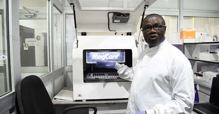 Professor Christian Happi, director of the African Centre of Excellence for Genomics of Infectious Diseases, displays one of the most advanced automated acid extractors being used in the laboratory.
- Source: Pius Utomi Ekpei/AFP via Getty Images