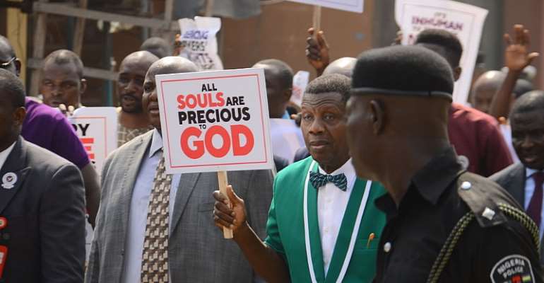 The General Overseer of the Redeemed Christian Church of God, Enoch Adeboye, holding a placard, leading a protest in Lagos. - Source: Olukayode Jaiyeola/NurPhoto/Getty
