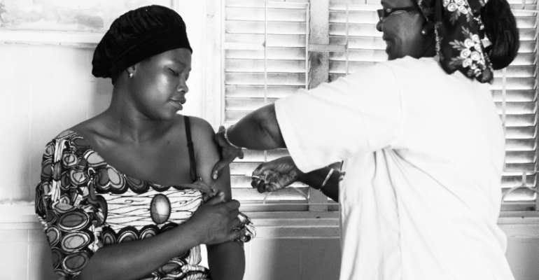 Fatou Hane administers a contraceptive injection to Ramatoulaye Mane at the Croix Rouge health post in Pikine, Dakar, Senegal.