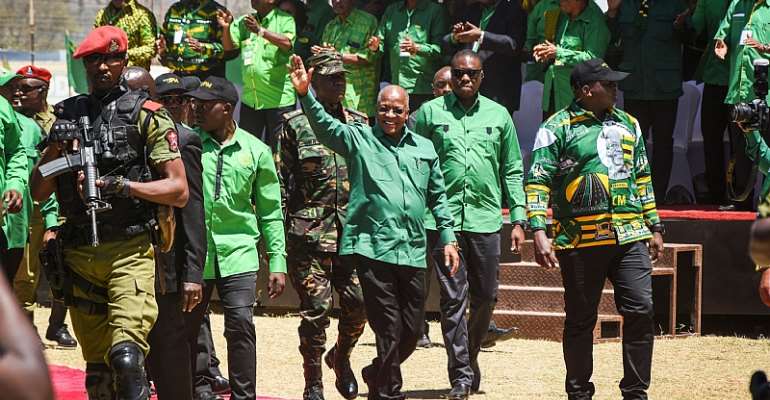 John Magufuli (centre) waves as he arrives to give a speech at a campaign rally in August 2020. - Source: