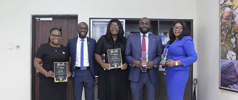 Matilda Asante-Asiedu (1st from right) and Olumide Olatunji (2nd from right) with some team members of the Bank