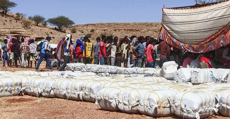 Ethiopian refugees fleeing fighting in Tigray province queue to receive supplies at the Um Rakuba camp in Sudan's eastern Gedaref province. - Source: Ebrahim Hamid/AFP via Getty Images