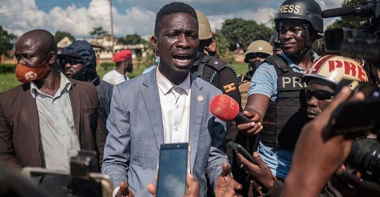Ugandan musician-turned-politician Robert Kyagulanyi addresses the media after his car was shot at by police in eastern Uganda during his campaign. - Source: Photo by Sumy Sadurni/AFP via Getty Images