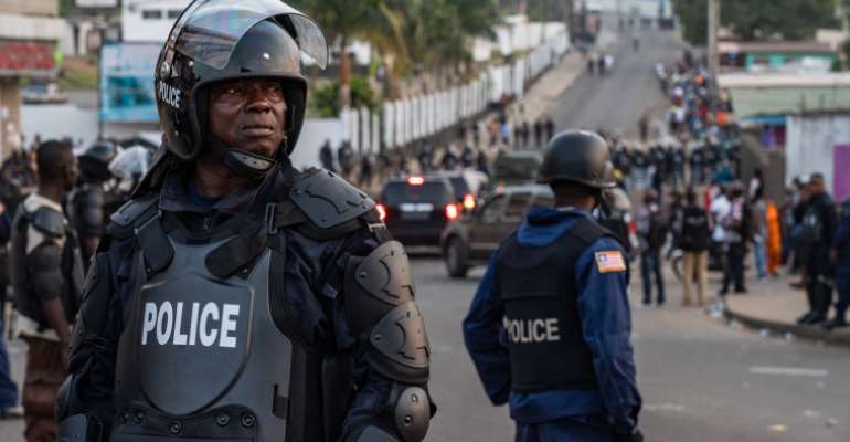 Police are seen in Monrovia, Liberia, on January 6, 2020. Liberian journalist Gloria Tamba has been in hiding since October. (AFP/Carielle Doe)