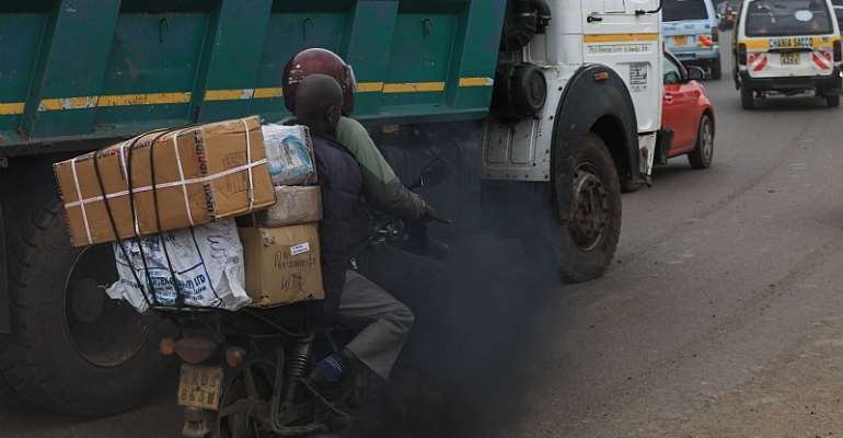 Black exhaust fumes from lorry envelope a motorcyclist and his passenger on a busy road in the Kenyan capital, Nairobi. - Source: EPA-EFE/Daniel Irungu