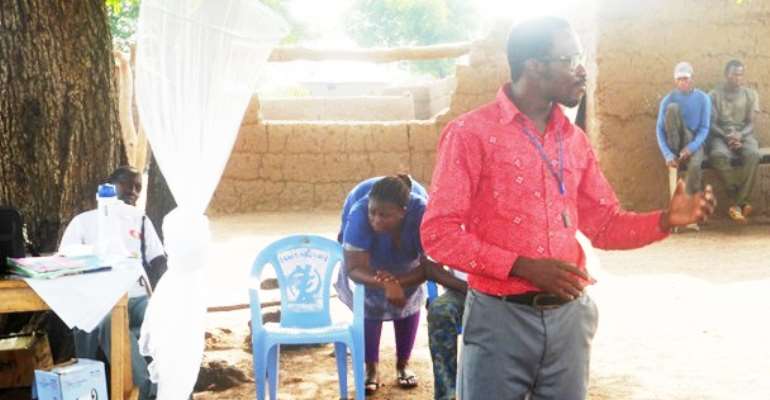 Titus Sotaa, A Community Health Nurse From The Tinga Health Centre, Educating Latiegberi Community Residents On The Ebola Virus On, April 4th, 2014.