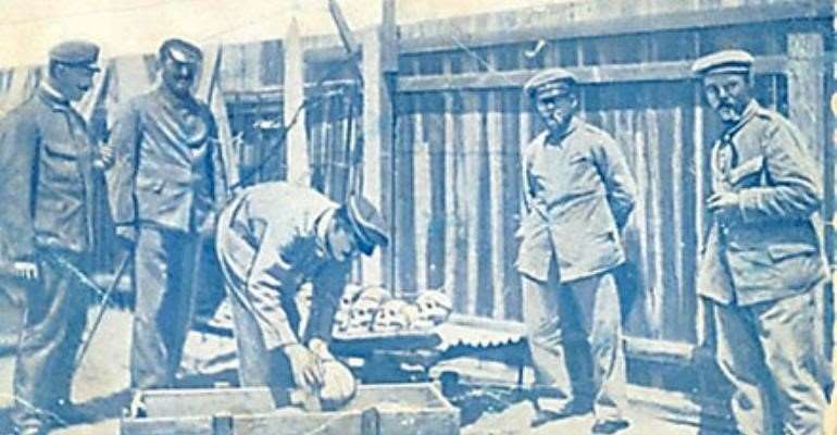 German soldiers loading human skulls and bones of massacred Herero into a casket for shipping to German universities, especially, Berlin.