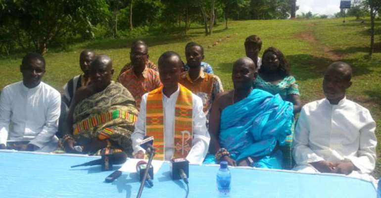 Rev Fr Paintsil addressing the media as other church members look on