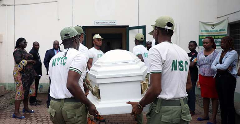 Members of the National Youth Service Corp carry the body of their colleague, the reporter Precious Owolabi, in Abuja on July 23. Owolabi was shot while covering protests in the Nigeria capital. (AFP/Kola Sulaimon)