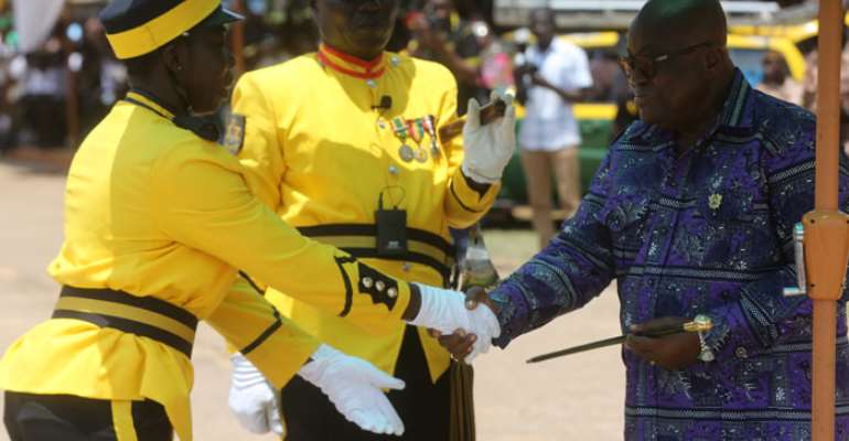 President Akufo-Addo presenting a Commandant Award to JUO Asomaning Mabel.