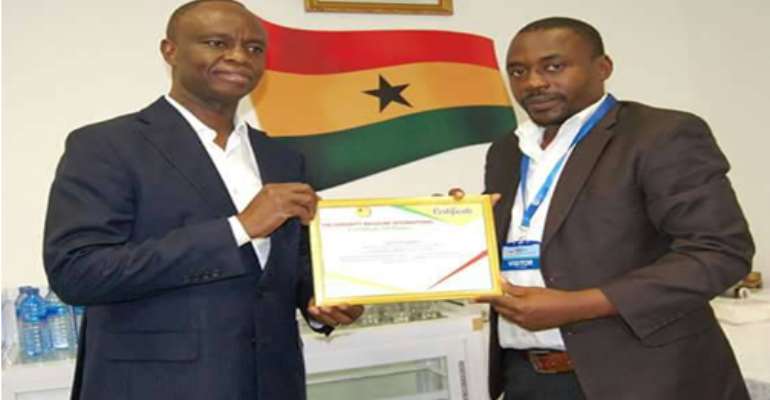 Mr. Joe Anokye (L) receiving a certificate of recognition from Mr Yahaya Alhassan (R)