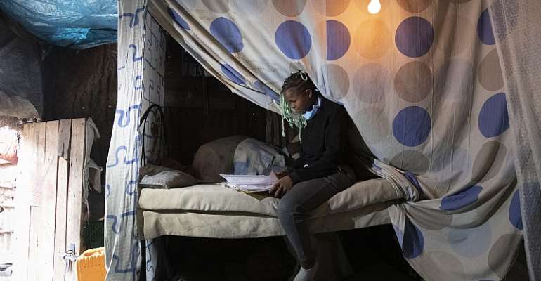 Rebecca, 18, studies in the top bunk she sleeps in with her two
younger sisters.