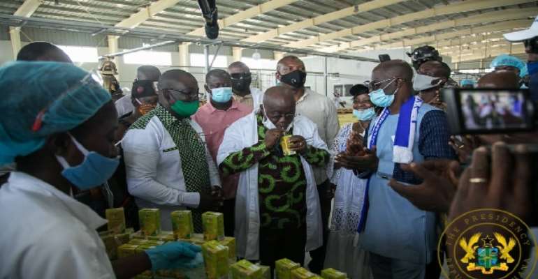 President Nana Akufo-Addo drinking Eku juice at the factory during opening ceremony