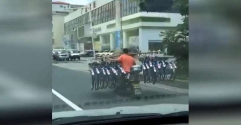 Man Carries 16 Bikes While Riding Motor Scooter