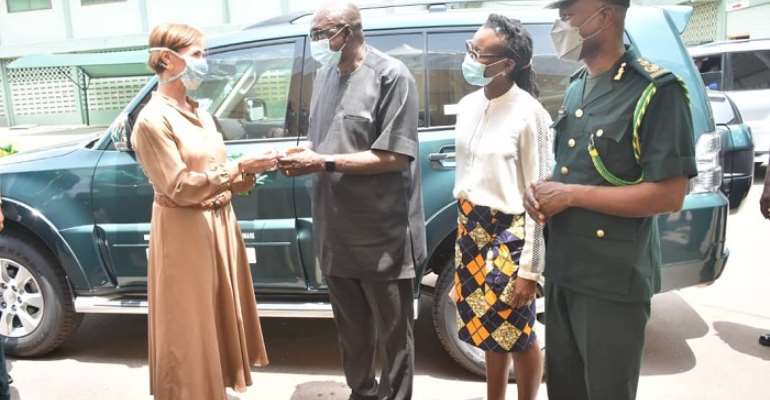 The deputy head of mission presenting the items to the Interior Minister as the CGI looks on
