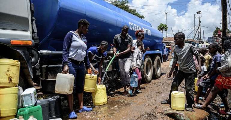 Residents of Kibera slum carry jerrycans to fill them with water from a bowser. - Source: Gordwin Odhiambo/AFP via Getty Images