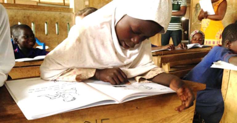 A student reads a book in her mother-tongue—Dagbani, a Northern Region language. The United States, through USAID, works with Ghana’s Ministry of Education to increase the number of children reading in early grades. Photo Credit: Adama Jehanfo, USAID/Ghana