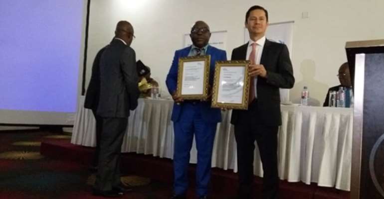 Mr. Kakari Addo (middle) displaying the certificates alongside UNIDO Project Manager, Pablo