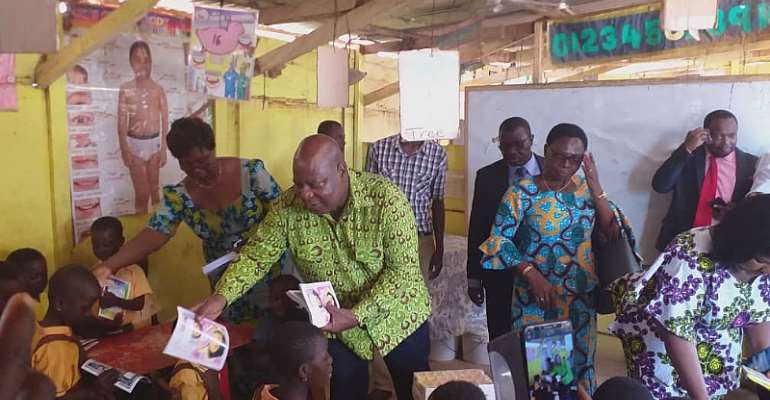 The Greater Accra Regional Minister, Hon. Ishmael Ashitey Distributing the Books to the School Children